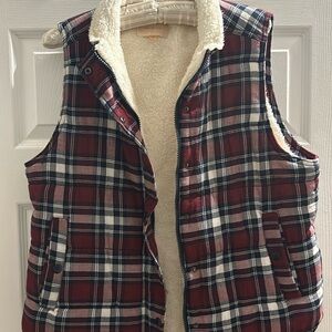 Warm, fuzzy vest. Has zipper and snaps down front and on pockets.